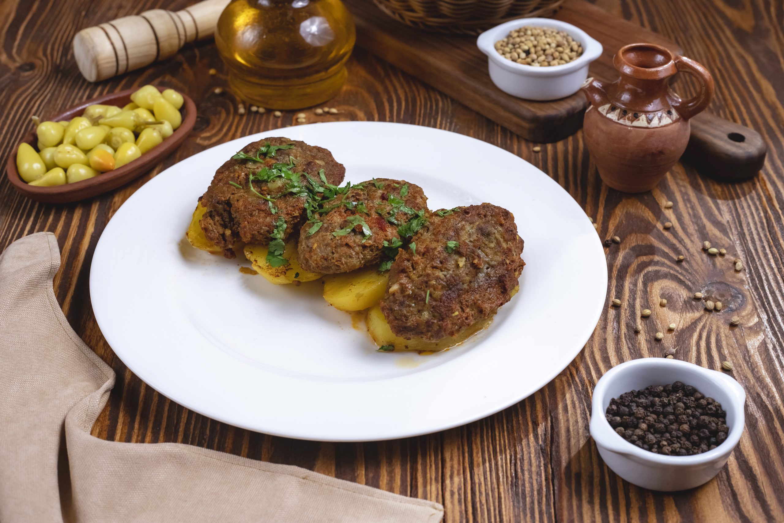 meat cutlets with potato spices greens side view
